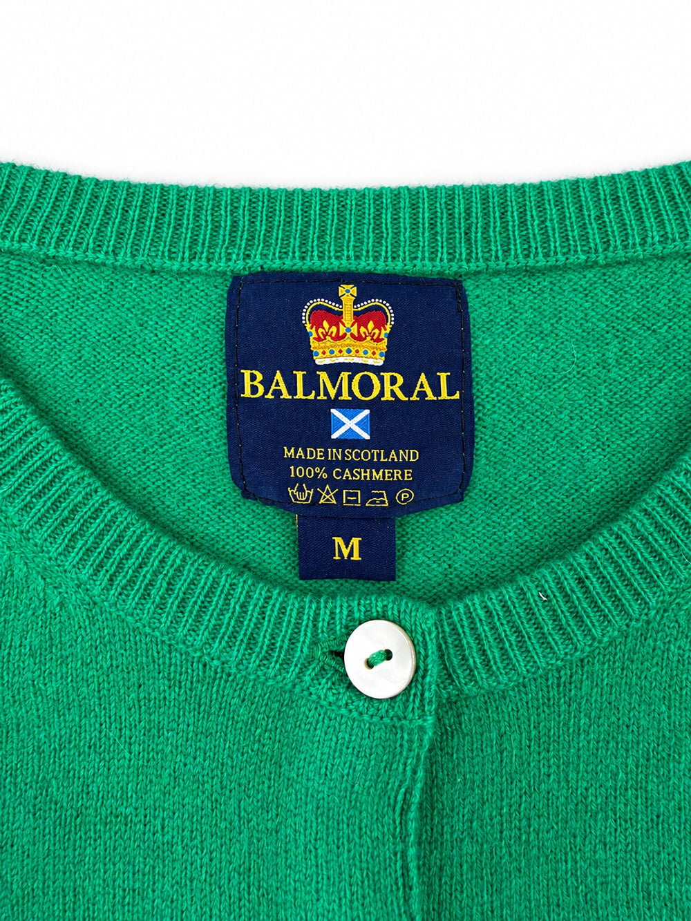 Balmoral green cashmere cardigan neckline and label showing Made in Scotland and 100% cashmere.
