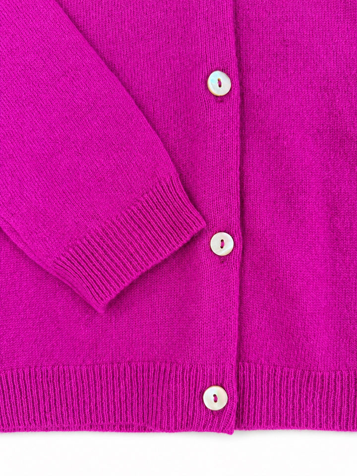 Close-up of the Balmoral pink cashmere cardigan cuff, ribbed hem and pearl buttons.