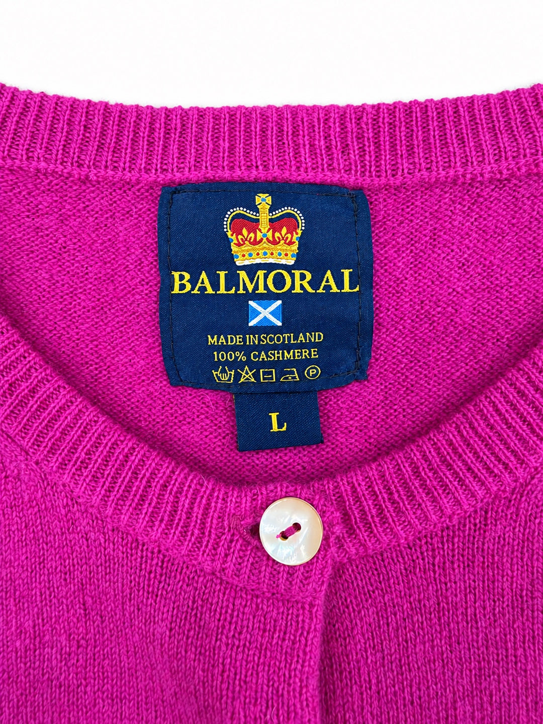 Balmoral pink cashmere cardigan neckline and label showing Made in Scotland and 100% cashmere.