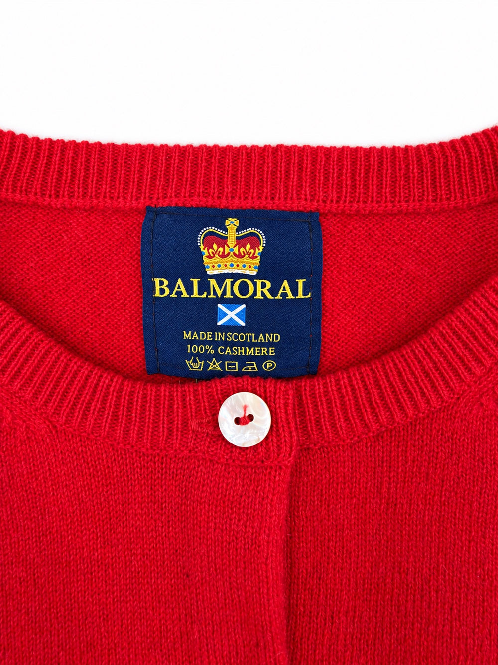 Balmoral red cashmere cardigan neckline and label showing Made in Scotland and 100% cashmere.