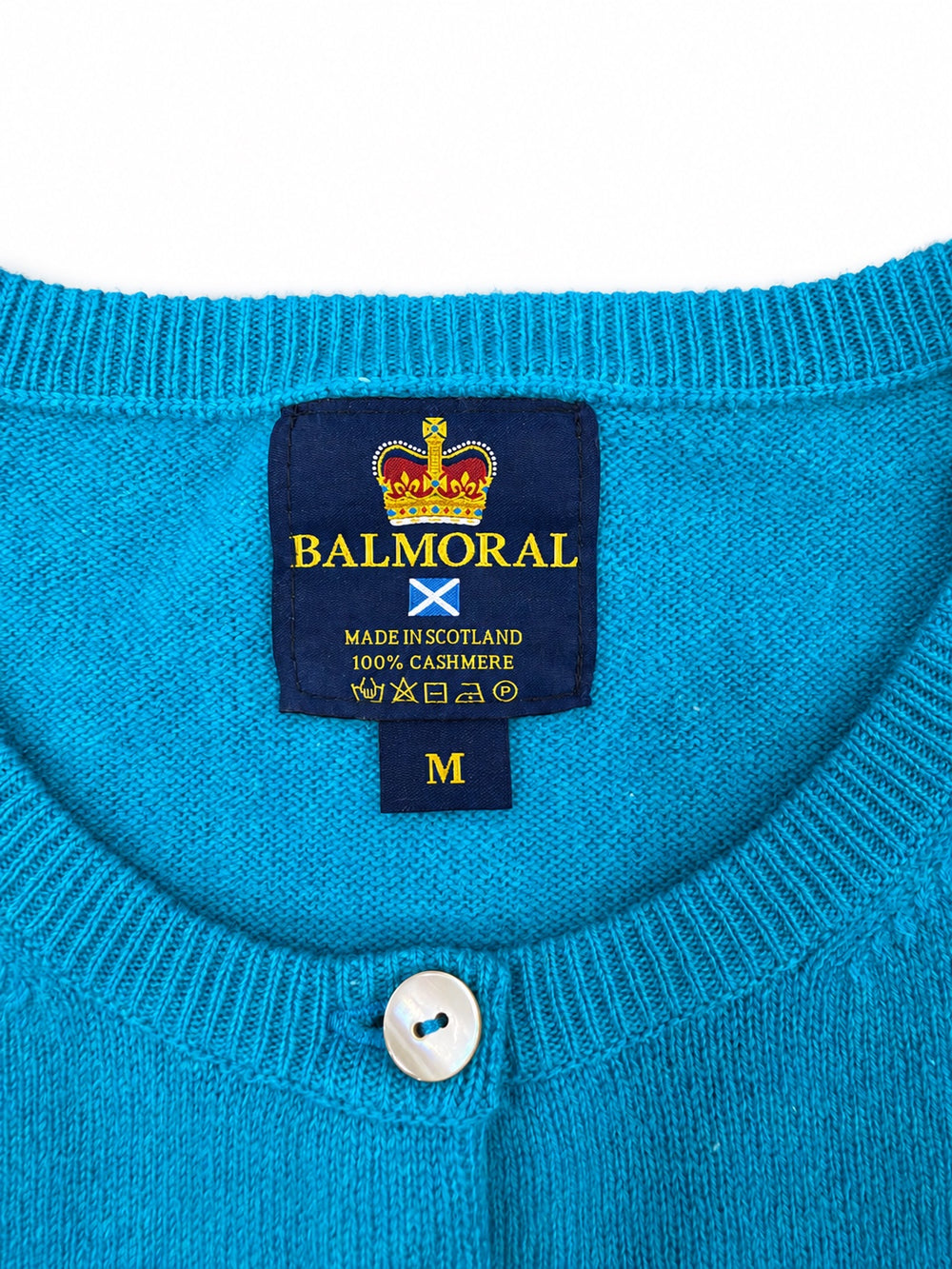 Balmoral turquoise cashmere cardigan neckline and label showing Made in Scotland and 100% cashmere.