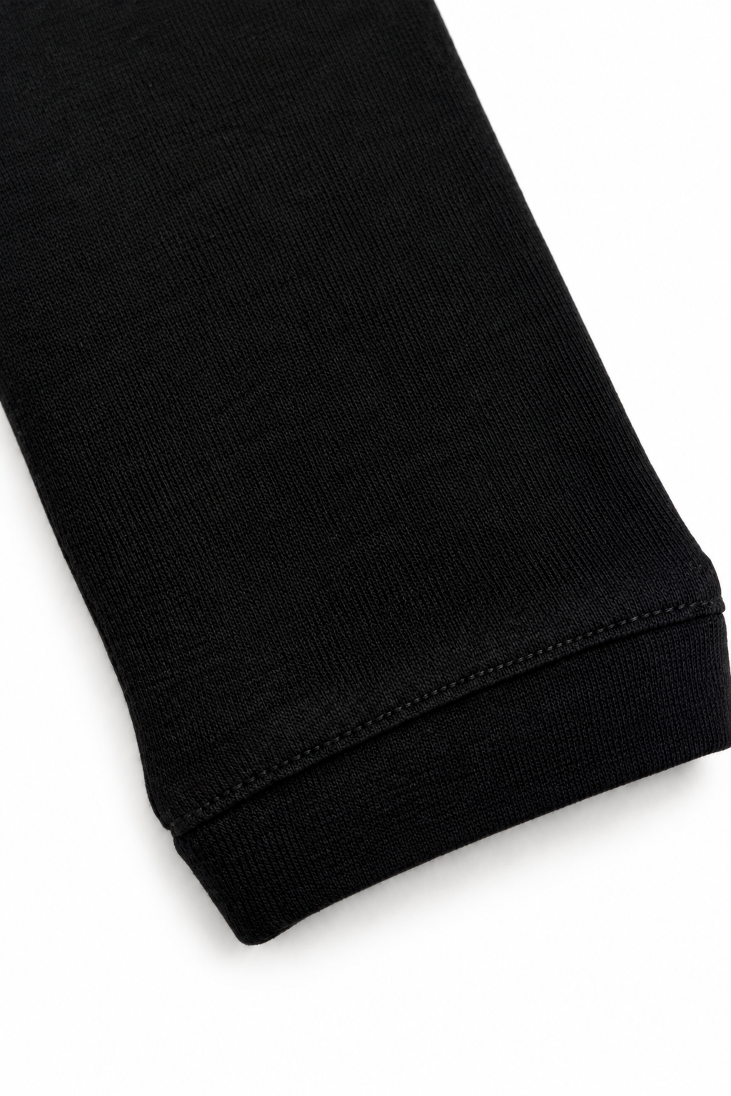 Black merino wool crew neck, cuff view on white background