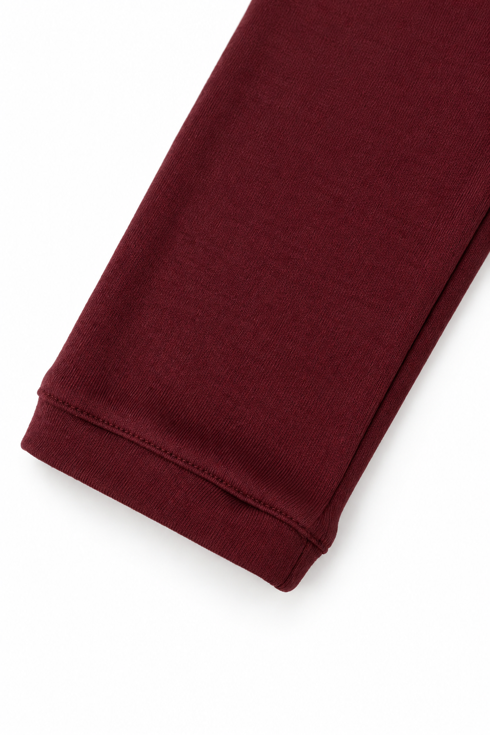 Burgundy merino wool crew neck, cuff view on white background