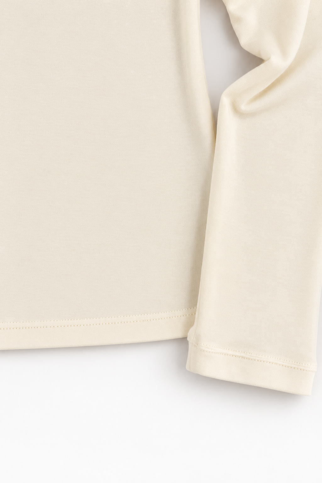 Ivory Tencel and merino wool top, sleeve cuff and hem detail