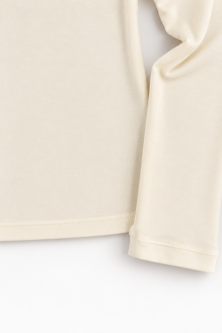 Ivory Tencel and merino wool top, sleeve cuff and hem detail