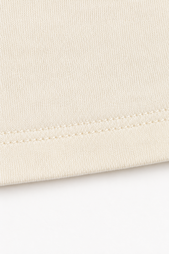 Ivory Tencel and merino wool jersey, close-up of fine knit texture and hem stitching