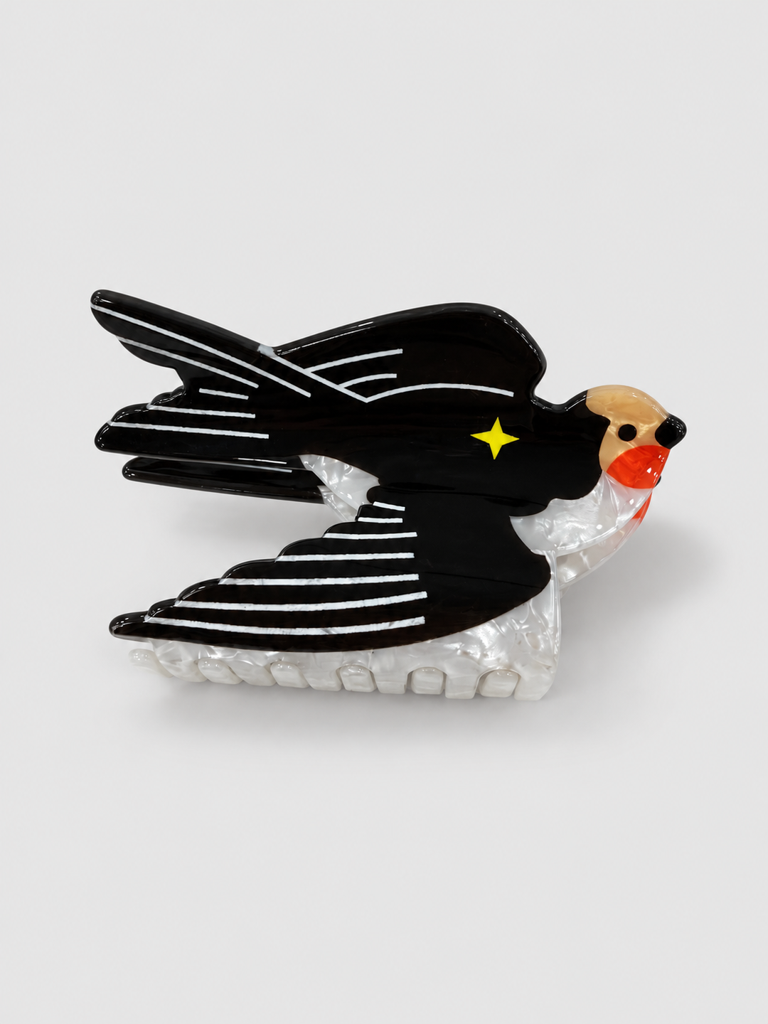 Swallow hair claw clip with black wings, white feather lines, pearly underside, red throat and yellow star
